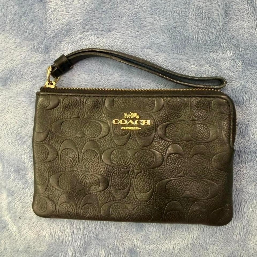 Coach black β wristlet with gold hardware
